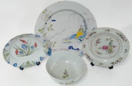 Three tin-glazed earthenware plates, of polychrome floral and reclining Chinaman decoration,