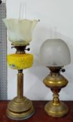 Two oil lamps, one of floral painted yellow porcelain, together with an English delftware plate, a