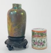 A Chinese miniature lidded Famille Rose pot, together with an iridescent vase on a wooden stand.