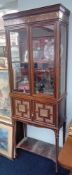 A 19th century rosewood and ivory marquetry inlaid display cabinet, fitted with two glazed doors