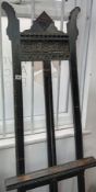 A dark carved oak picture easel.