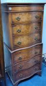 A reproduction walnut chest on chest of small proportions, serpentine outline, fitted with a