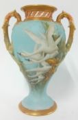 A Royal Worcester Twin Handled Vase by Charles Baldwin, dated 1906, of urn shaped form, painted to