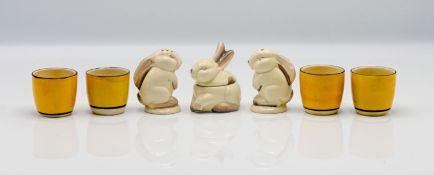 A set of four Clarice Cliff yellow egg cups, together with a novelty cruet set in the form of