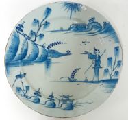 An 18th century English Delft plate, decorated with Chinaman and pheasant in a landscape, double