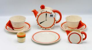 A Clarice Cliff 'Eight O'Clock' pattern 'Bon Jour' shape teapot, together with milk jug, three