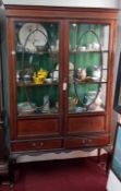 An Edwardian inlaid mahogany two door display cabinet, fitted with two doors on cabriole legs. Width
