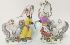 A pair of Meissen J J Kändler style groups of Stallions and Grooms, circa mid 18th century, unmarked