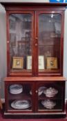 A Victorian mahogany library bookcase. Upper section fitted with shelves and glazed, the lower