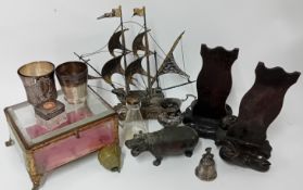 A collection of various items, to include a glass box, metal model ship, hippo, lady bell, and other