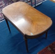 An old reproduction mahogany coffee table inlaid with gilded decoration and fluted legs. Height