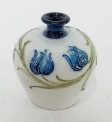 A McIntyre Moorcroft small vase, decorated with blue tulips, circa 1897-1913, signed by William