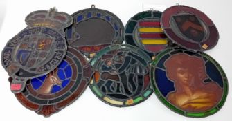 A collection of stained glass roundels, windows, etc, together with a coat of arms painting, and