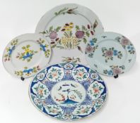Four tin-glazed earthenware plates, decorated with polychrome floral motifs. (4)