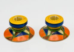 A pair of Clarice Cliff 311 shape candlesticks, geometric pattern. (2)
