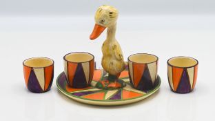 A Clarice Cliff 'Mr Puddleduck' egg dish, together with four egg cups, Bizarre mark to base, circa