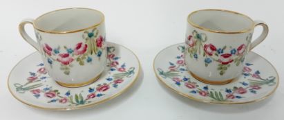 A McIntyre Moorcroft pair of teacups and saucers, circa 1897-1913, signed by William Moorcroft to