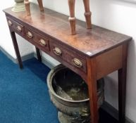 A Georgian oak narrow dresser fitted with three inlaid drawers. Width 161cm, depth 37cm.