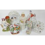 A collection of six various 19th century Staffordshire figures, and a porcelain figure (7).