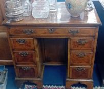A William and Mary style walnut kneehole desk, the walnut veneered figured top herringbone strung