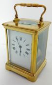 A brass-cased carriage clock, striking on a gong, height 15cm (handle up).