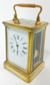 A brass-cased carriage clock with push button repeat, striking on a gong. Height 18cm (handle up).