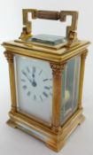 A brass-cased carriage clock, of small proportions with Corinthian columns, striking on a gong,