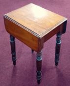 A 19th century mahogany work table fitted with a real and a dummy drawer on turned legs.