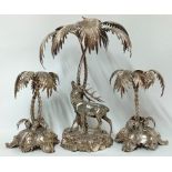 A pair of silver plated palm tree table pieces, together with a matched centrepiece of a stag and