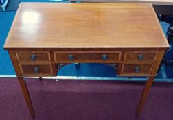 An Edwardian inlaid mahogany and crossbanded kneehole writing desk fitted with five drawers.