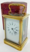 A brass-cased carriage clock, the dial with roman numeral. Height 18cm (handle up). Together with an