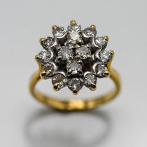A diamond cluster ring set with sixteen diamonds, shaped into a cross in the middle, set in 18ct