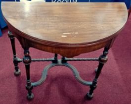 A Victorian Mahogany D-shaped fold over gaming table with folding legs.