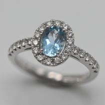 A diamond and aquamarine cluster ring, with further diamonds to the shoulders, size L, approx 3.5g.