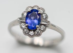 A diamond and tanzanite cluster ring, set in 18ct white gold, size M.
