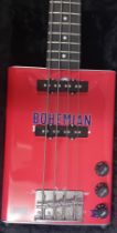 A Bohemian Bass Guitar, made from an oil tin, cased.