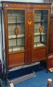 An Edwardian mahogany inlaid two door display cabinet.