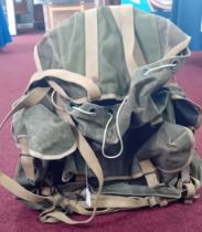 A WWII commando rucksack by Nesta Ltd, khaki canvas, dated 1944 to interior with military arrow.