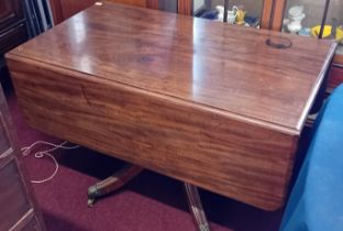 A 19th century two flap pedestal supper table.