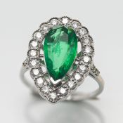 A large 'Pear' shape emerald and diamond ring, set in white metal (not hallmarked), size R.