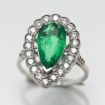 A large 'Pear' shape emerald and diamond ring, set in white metal (not hallmarked), size R.