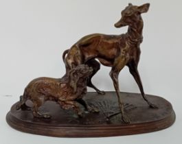 A spelter group by PJ Mene, of two dogs, signed to base.