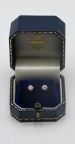 A pair of single stone diamond stud earrings, set in 18ct white gold.