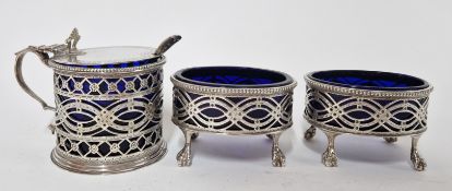 An art nouveau silver cruet set, of intricate pieced design with blue glass inserts, to include