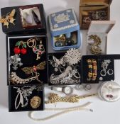 A collection of costume jewellery including a Butler & Wilson Tiger brooch, beads, bangles etc.