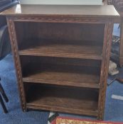 A small oak bookcase with carved motif, height 91cm, width 76cm.