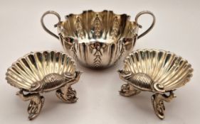 A pair of early 20th century silver salts, of scallop shells raised on fish supports, hallmarked