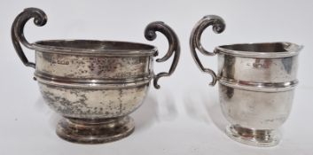 An early 20th century milk jug and sugar bowl, with scroll handles, hallmarked Sheffield 1910,