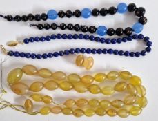 A Lapis Lazuli bead necklace, length 43cm, a light coloured amber bead necklace with two loose beads