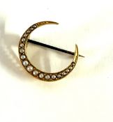 A gold half crescent brooch set with seed pearls (not hallmarked), approx 2.4g.